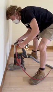 NWF tradesperson sanding a timber floor
